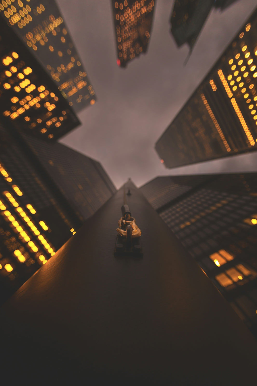 a small toy car is driving through a city at night