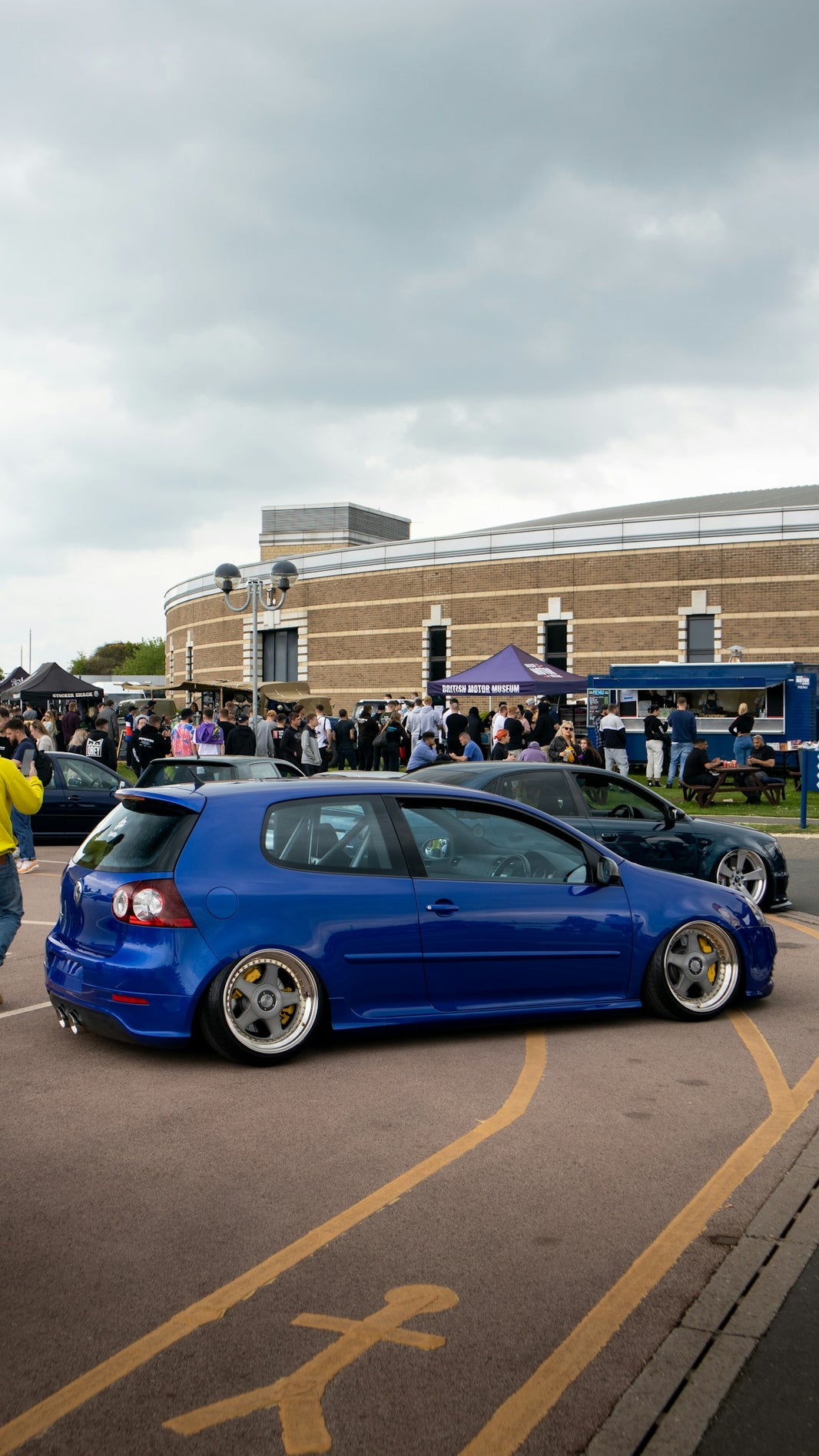 a blue car parked on the side of a road