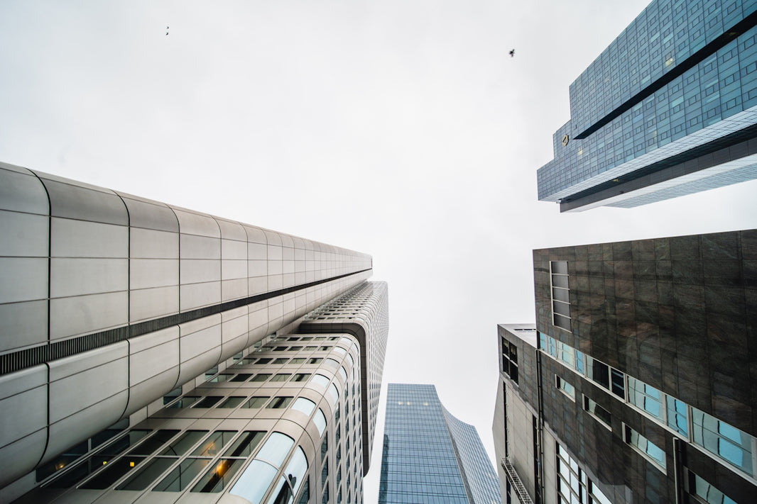 looking up at tall buildings in a city